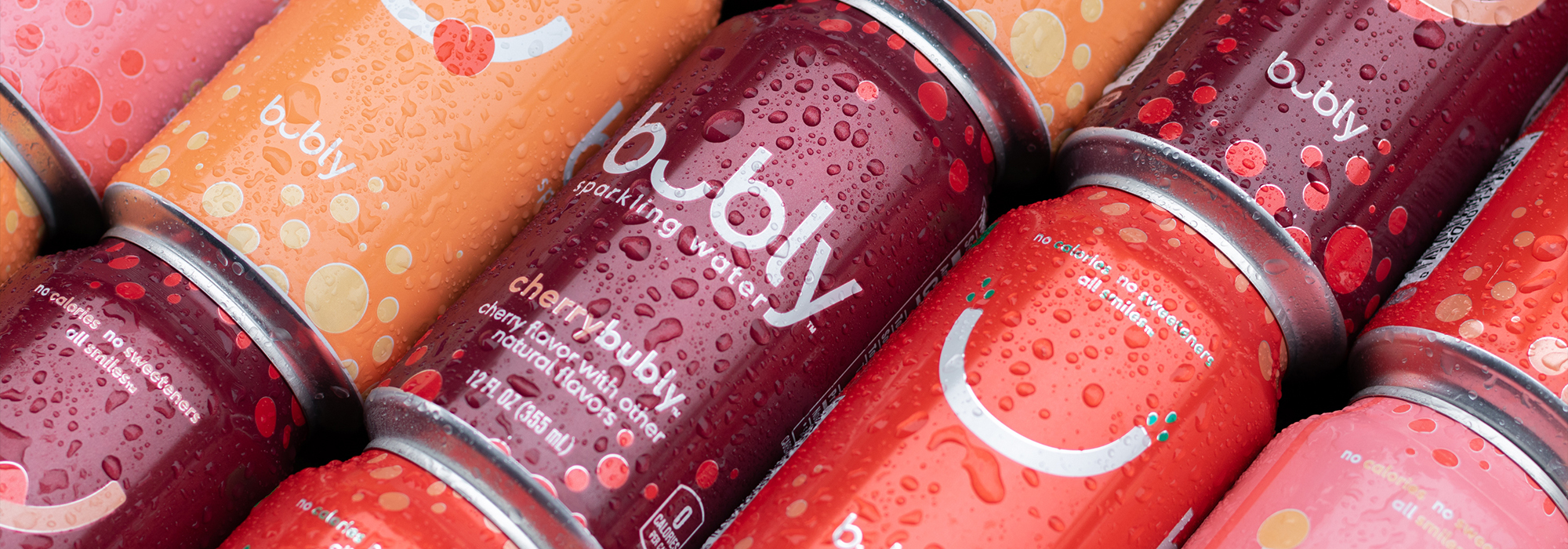 Colorful Bubly sparkling water cans laying in a diagonal pattern