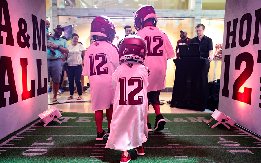 Children running out of mock Kyle Field tunnel