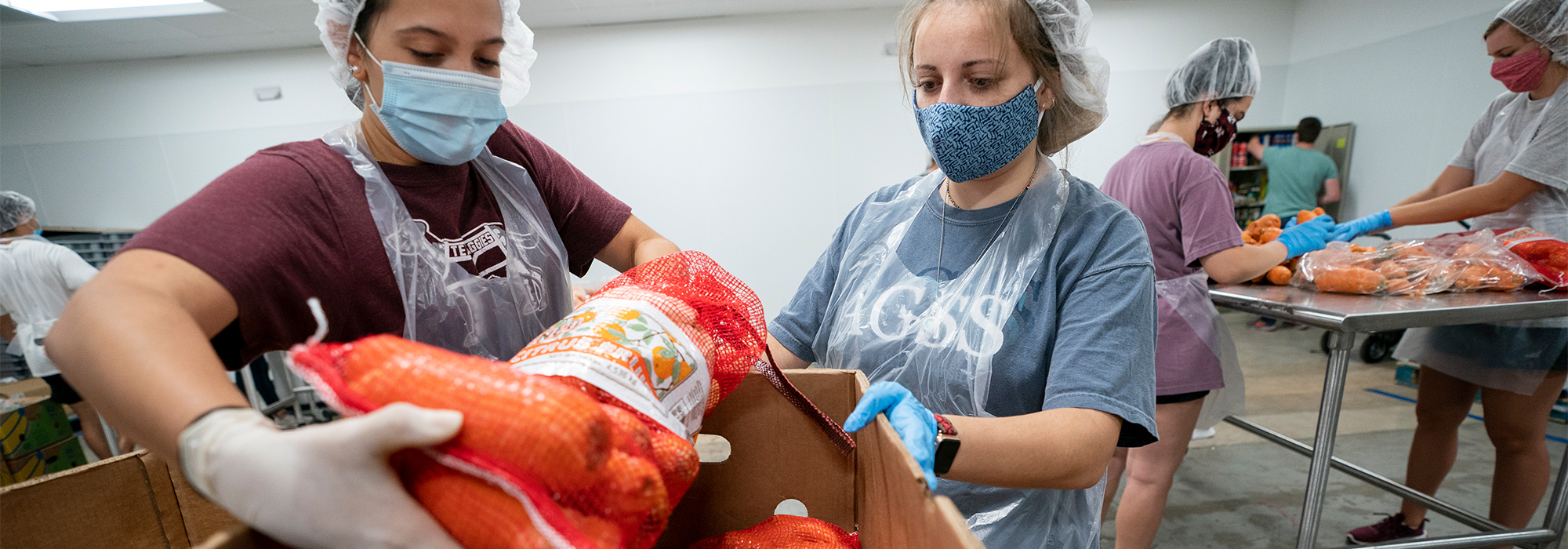 TAMU students working to load food at the Brazos Valley Food Bank