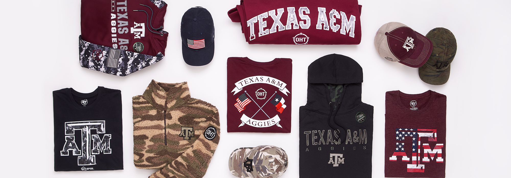 TAMU and Operation Hat Trick branded merchandise laid out on a white background. Some items include hats, sweatshirts, t-shirts, and blankets.