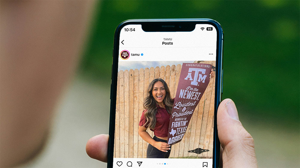 Phone showing an instagram post from Texas A&M of an incoming freshman holding their admittance banner