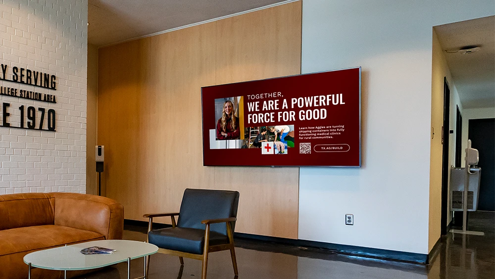 Digital signage in a reception area featuring the message "Together, we are a powerful force for good."
